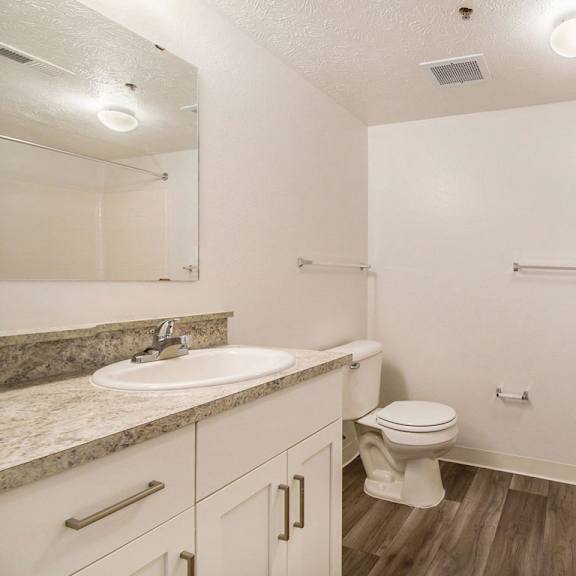 Thumbnail 11 of 20 A bathroom with a sink, toilet, and bathtub at West Hampton Park Apartments in Elkhorn, NE 68022