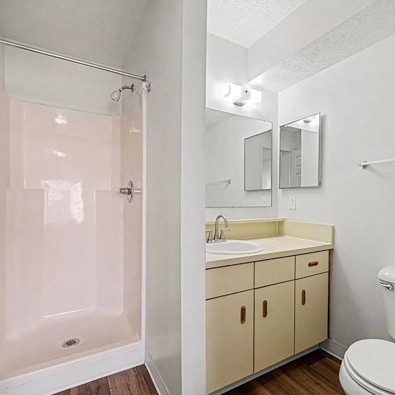 Thumbnail 19 of 19 A white bathroom with a toilet, sink, and shower  at West Hampton Park Apartment Homes, Nebraska, 68022