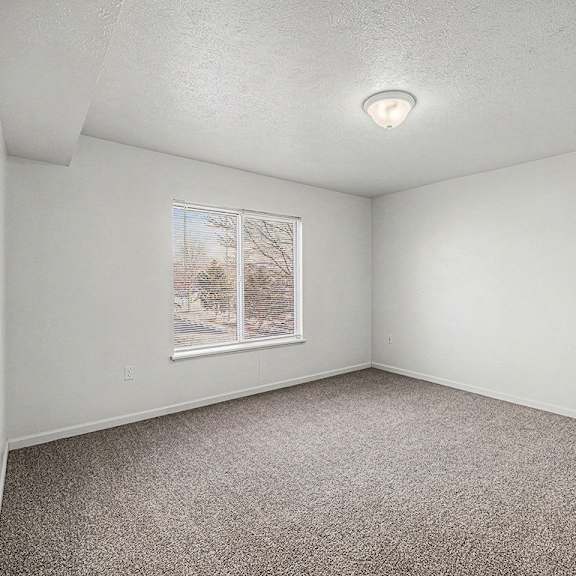 Thumbnail 16 of 19 A bedroom with a window and carpeted floor  at West Hampton Park Apartment Homes, Nebraska, 68022