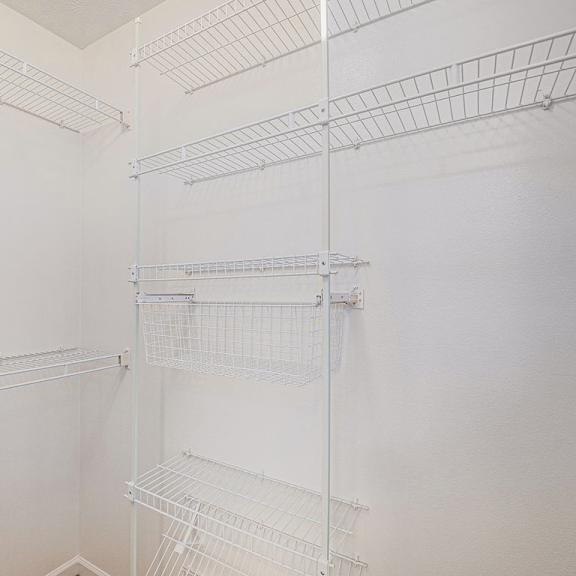 Thumbnail 18 of 19 A walk-in closet with wardrobe organizers at West Hampton Park Apartments in Elkhorn, NE 68022