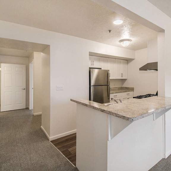 Thumbnail 8 of 20 A kitchen area with a breakfast bar at West Hampton Park Apartments in Elkhorn, NE 68022