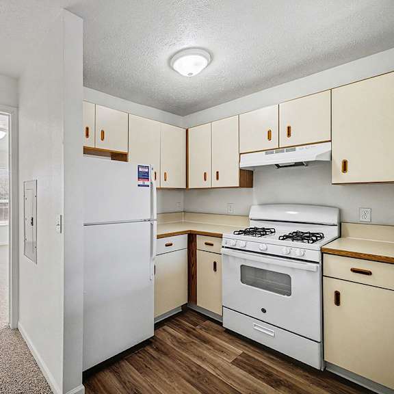 Thumbnail 8 of 19 A kitchen with white appliances and wooden cabinets  at West Hampton Park Apartment Homes, Nebraska, 68022