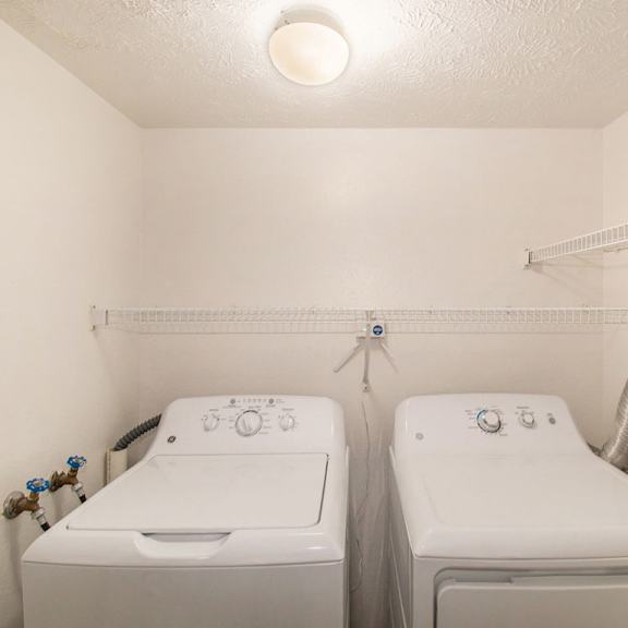 Thumbnail 10 of 20 A laundry room with a washer and dryer at West Hampton Park Apartments in Elkhorn, NE 68022