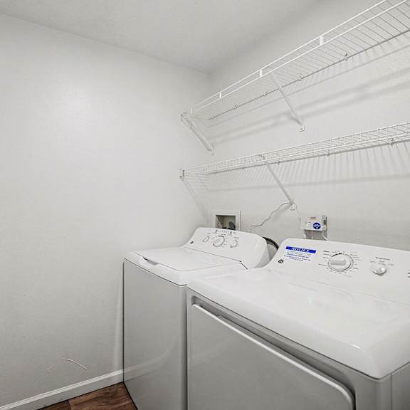 Thumbnail 11 of 19 A laundry room with a full-size washer and dryer at West Hampton Park Apartments in Elkhorn, NE 68022
