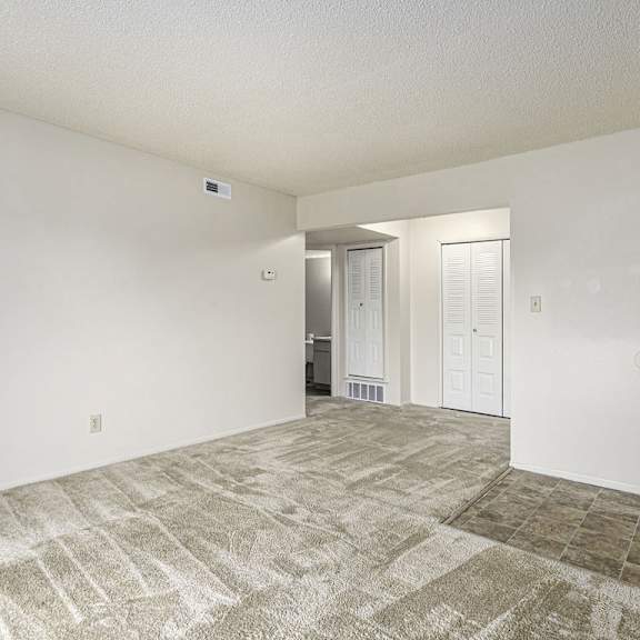 Thumbnail 5 of 10 A dining room with a carpeted floor and a closet at West Wind Apartments, Fort Wayne, 46808