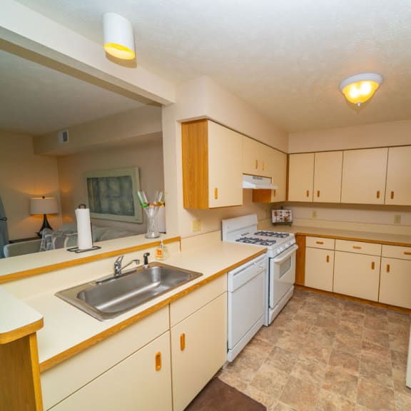 Thumbnail 8 of 14 A kitchen with white appliances and a washer/dryer at West Hampton Park Apartment Homes, Elkhorn