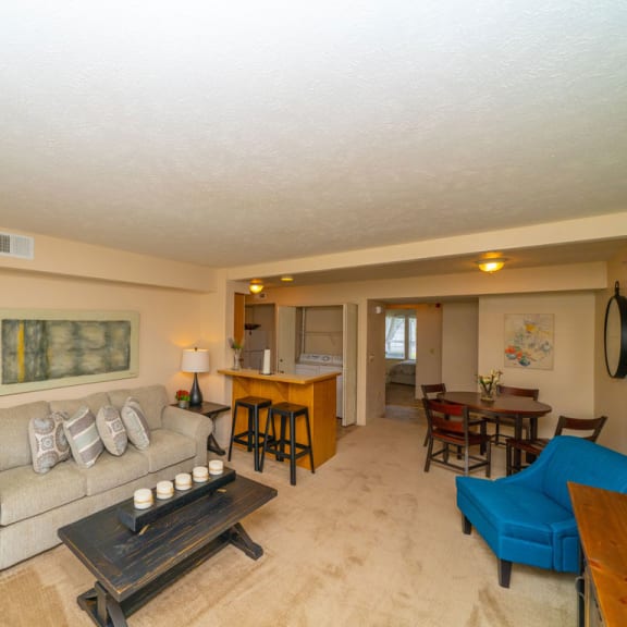 Thumbnail 5 of 14 A living and dining room with plush carpet at West Hampton Park Apartment Homes, Elkhorn, NE, 68022