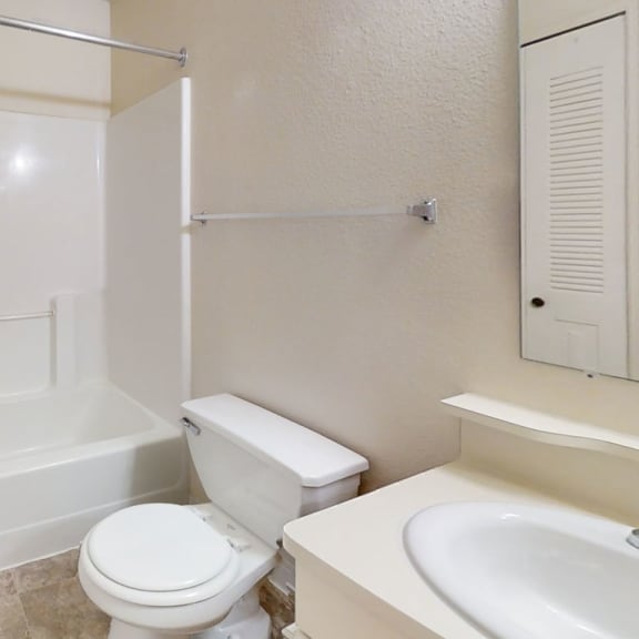 Thumbnail 12 of 20 A bathroom with a sink, toilet, and bathtub at West Hampton Park Apartment Homes, Elkhorn
