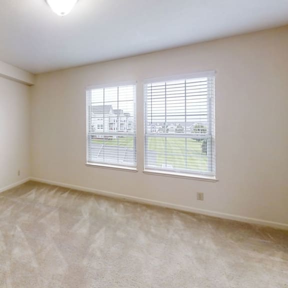 Thumbnail 14 of 20 A bedroom with large windows and a walk in closet at West Hampton Park Apartment Homes, Nebraska, 68022
