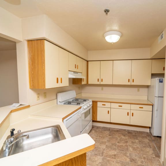 Thumbnail 6 of 10 Kitchen with dishwasher and washer and dryer  at Windmill Lakes Apartments, Holland, 49424