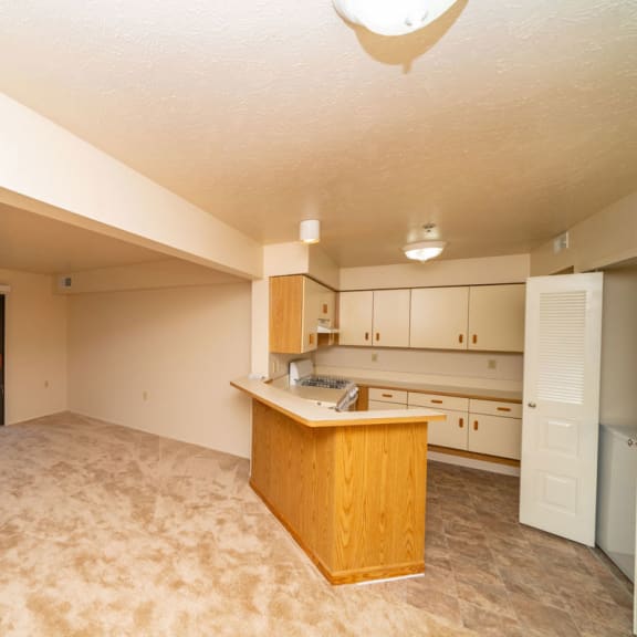 Thumbnail 5 of 10 A living room with a slider to a private patio at Windmill Lakes Apartments, Holland, MI