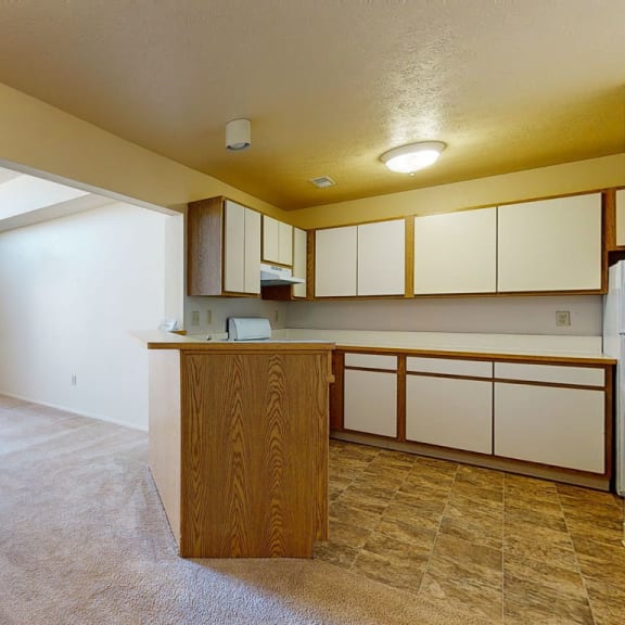 Thumbnail 4 of 10 Open floor plan featuring large living and dining rooms and a kitchen at Windmill Lakes Apartments, Holland, Michigan 49424