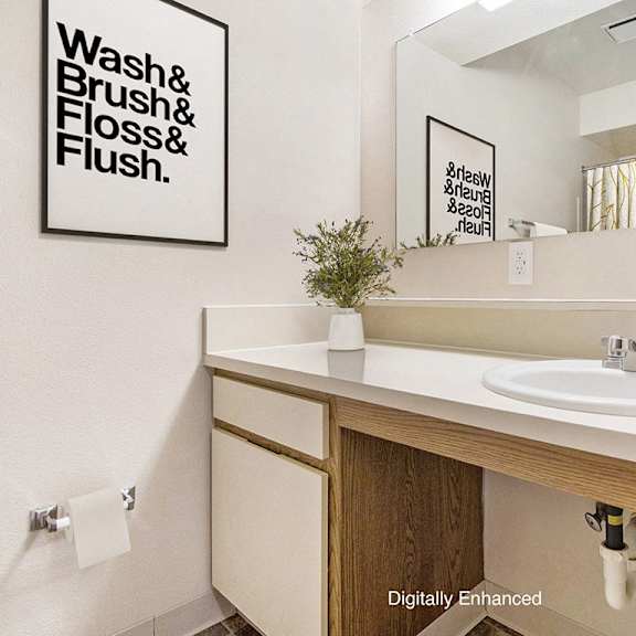 Thumbnail 8 of 10 A bathroom with a large vanity at Windmill Lakes Apartments, Holland, Michigan 49424