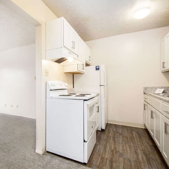 Thumbnail 5 of 13 An upgraded kitchen and living room at Wingate Apartments, Kentwood, MI
