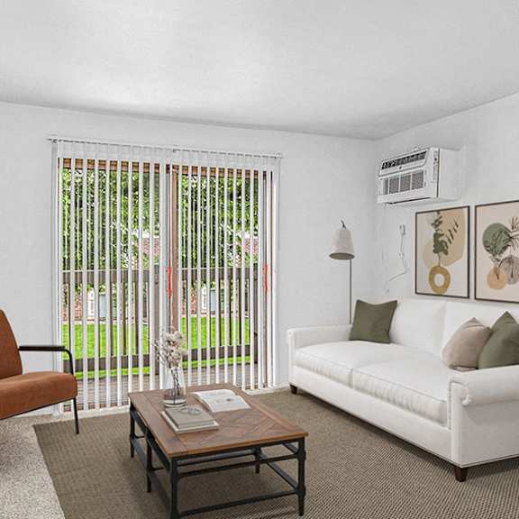 Thumbnail 3 of 12 A living room with a white couch, a brown chair, and a coffee table at Wingate Apartments, Michigan, 49512