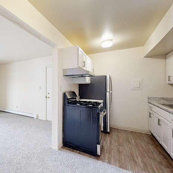 Thumbnail 3 of 8 An upgraded kitchen and living room with access to a patio at Wood Creek Apartments, Kenosha, WI, 53144