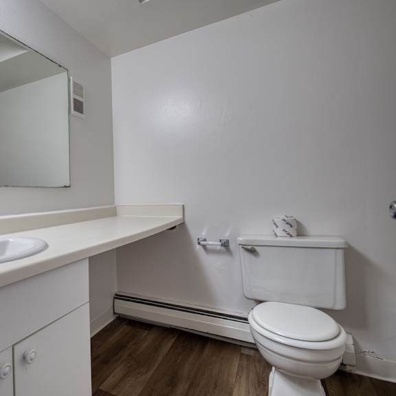 Thumbnail 7 of 14 A white bathroom with large vanity at Wood Creek Apartments, Kenosha, WI, 53144