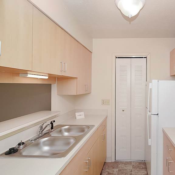 Thumbnail 3 of 8 A kitchen with a pantry and an electric stove at Wood Creek Apartments in Kenosha, WI
