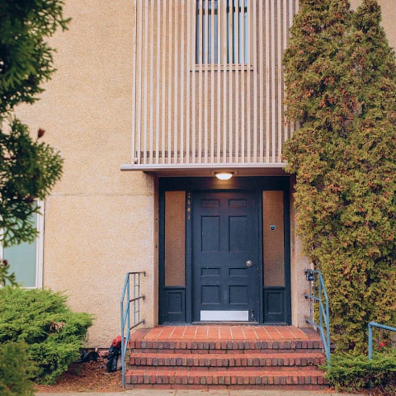 A black door is on the front of a building.