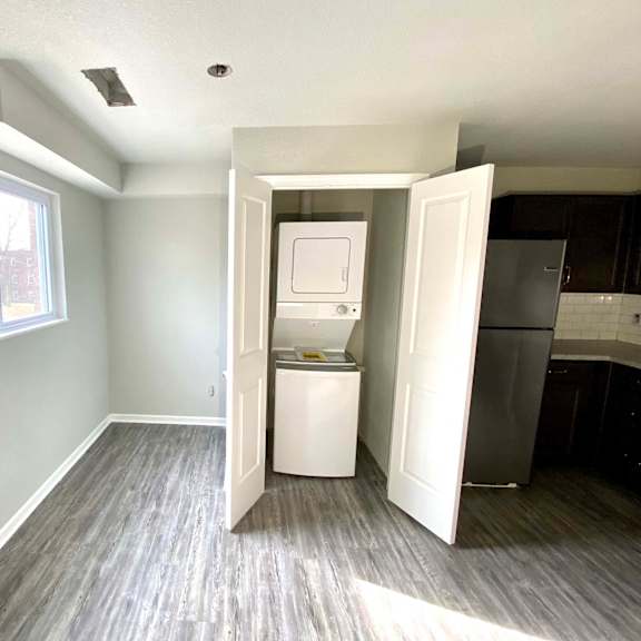 a kitchen area with a refrigerator and a cabinet.