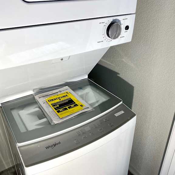 a white washing machine with a sticker on the door.