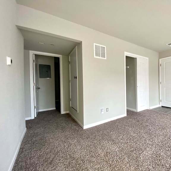 a room with carpeted floor and white walls.
