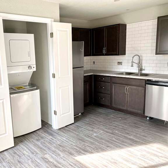 a kitchen with a white dishwasher and a white refrigerator.