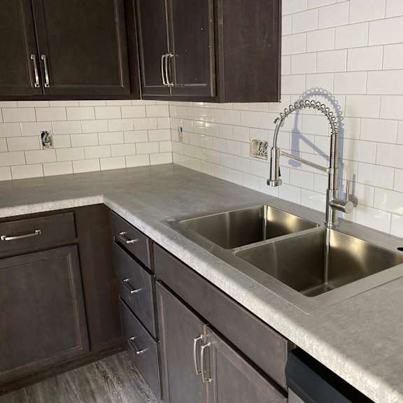 a kitchen with a sink and a faucet.