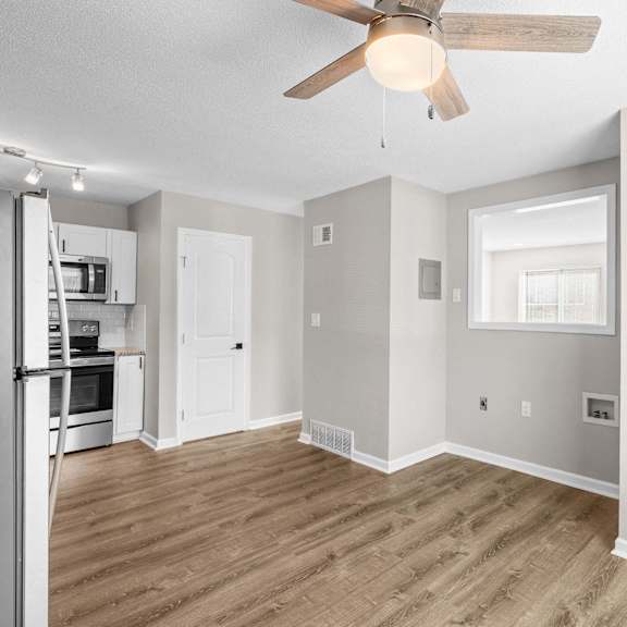 a spacious kitchen with a refrigerator, microwave, and oven.