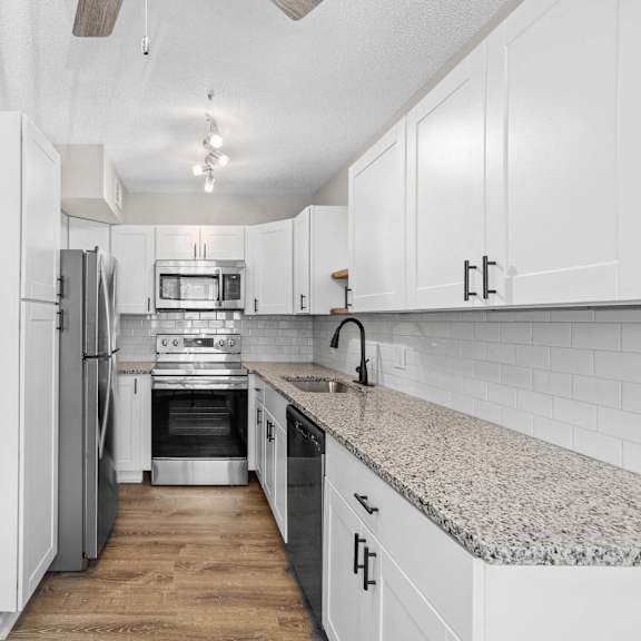 a kitchen with white appliances and cabinets.