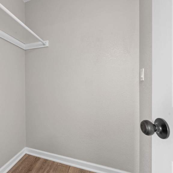 a room with a door and a shelf above it.