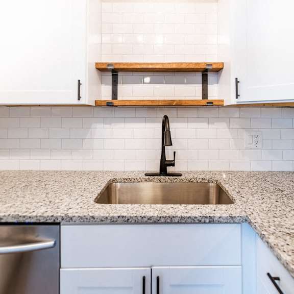 a kitchen with a sink and cabinets.