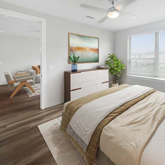 Thumbnail 5 of 5 A bedroom with a large bed and a painting on the wall.
