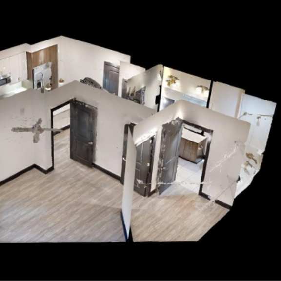 Thumbnail 6 of 10 A white room with a wooden floor and a large mirror on the wall.