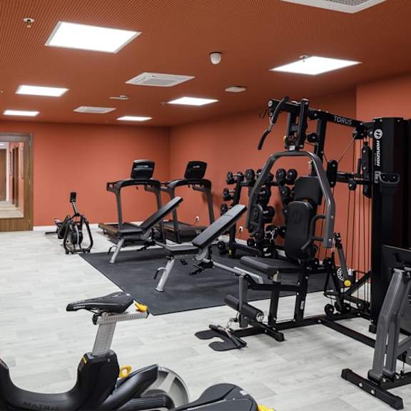 a gym with weights and other equipment in a room