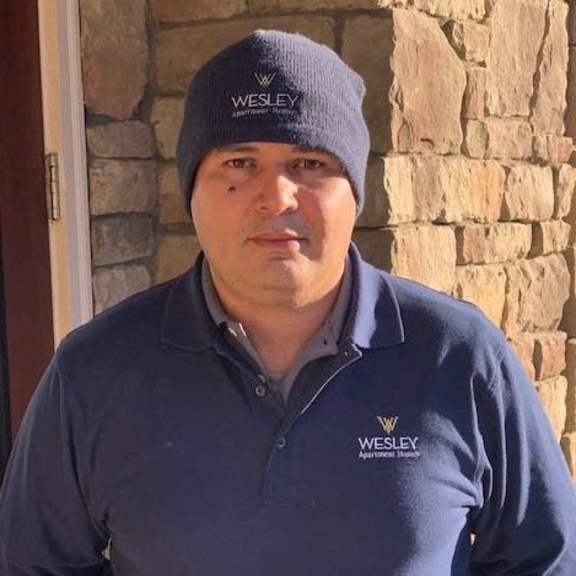 a man wearing a hat and a blue shirt