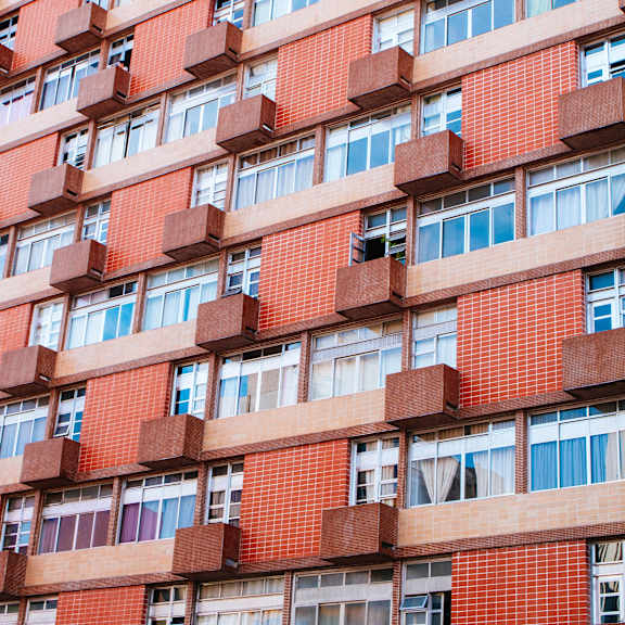a tall red brick building with many windows