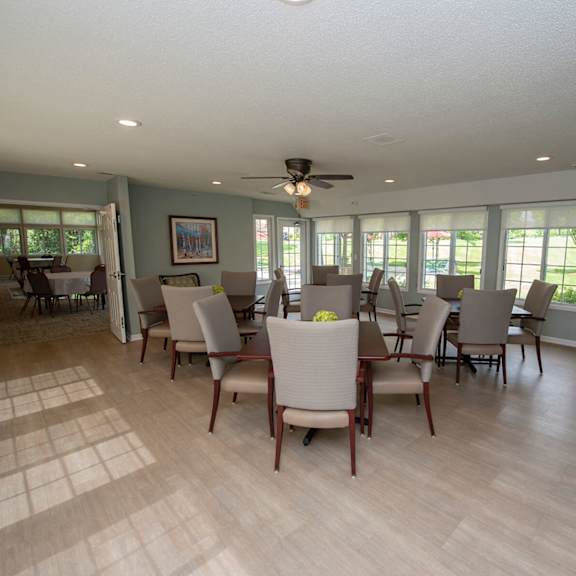 a living room with a dining table and chairs.