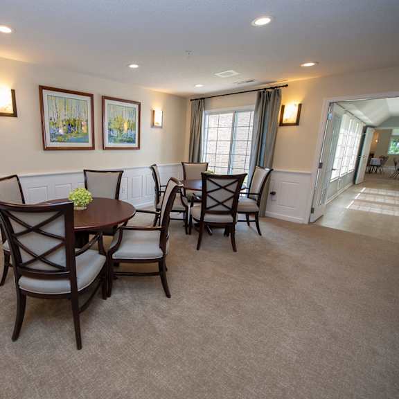 a dining room with a table and chairs.