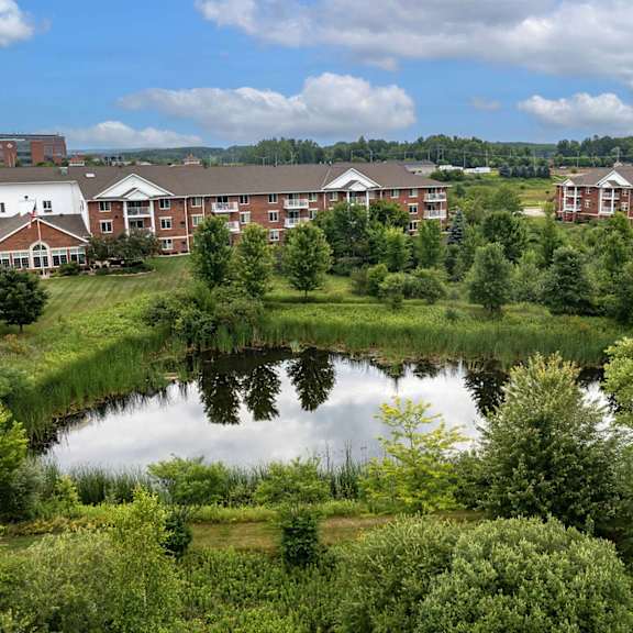 a view of a pond in front of a building