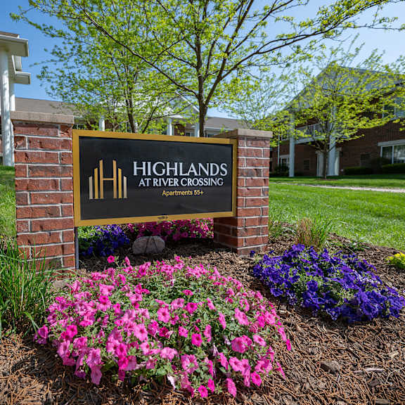 a sign for highlands at river crossing is in front of a building.