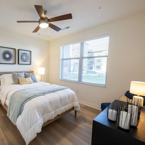 a bedroom with a ceiling fan and a bed