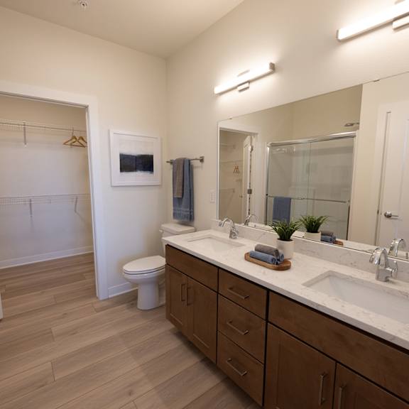 a bathroom with a large mirror and a sink and a toilet