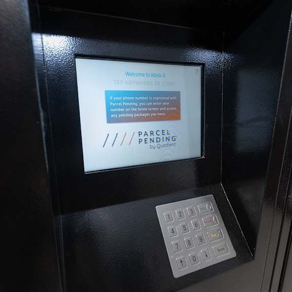 a digital screen on a parcel pickup box in a resident mailroom.