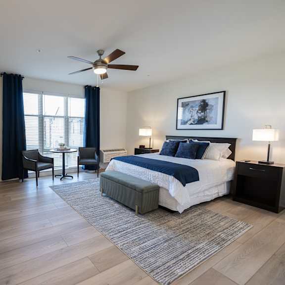 a bedroom with a large bed and a ceiling fan