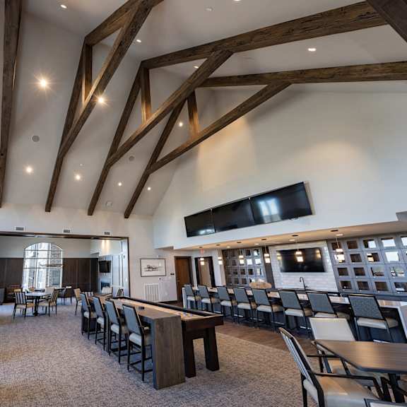 a large dining room with tables and chairs and a fireplace