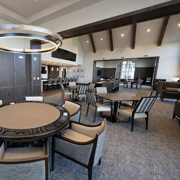 a large dining room with tables and chairs and a fireplace