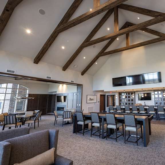 a large dining room with tables and chairs and a bar