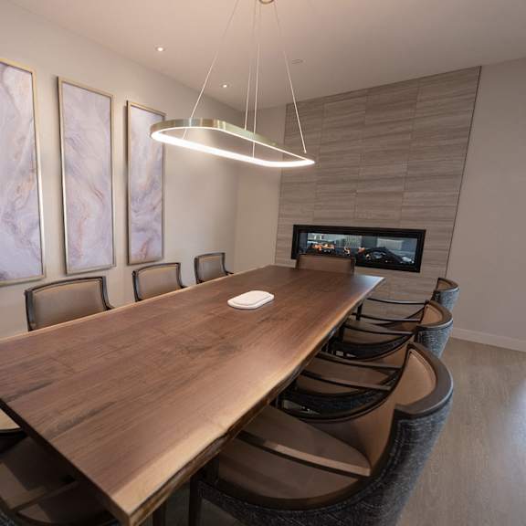 a conference room with a wooden table and chairs