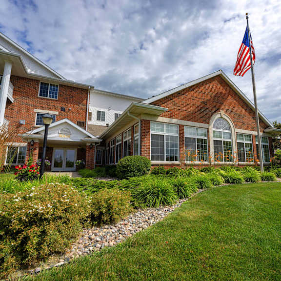 a large brick building with an american flag in front of it